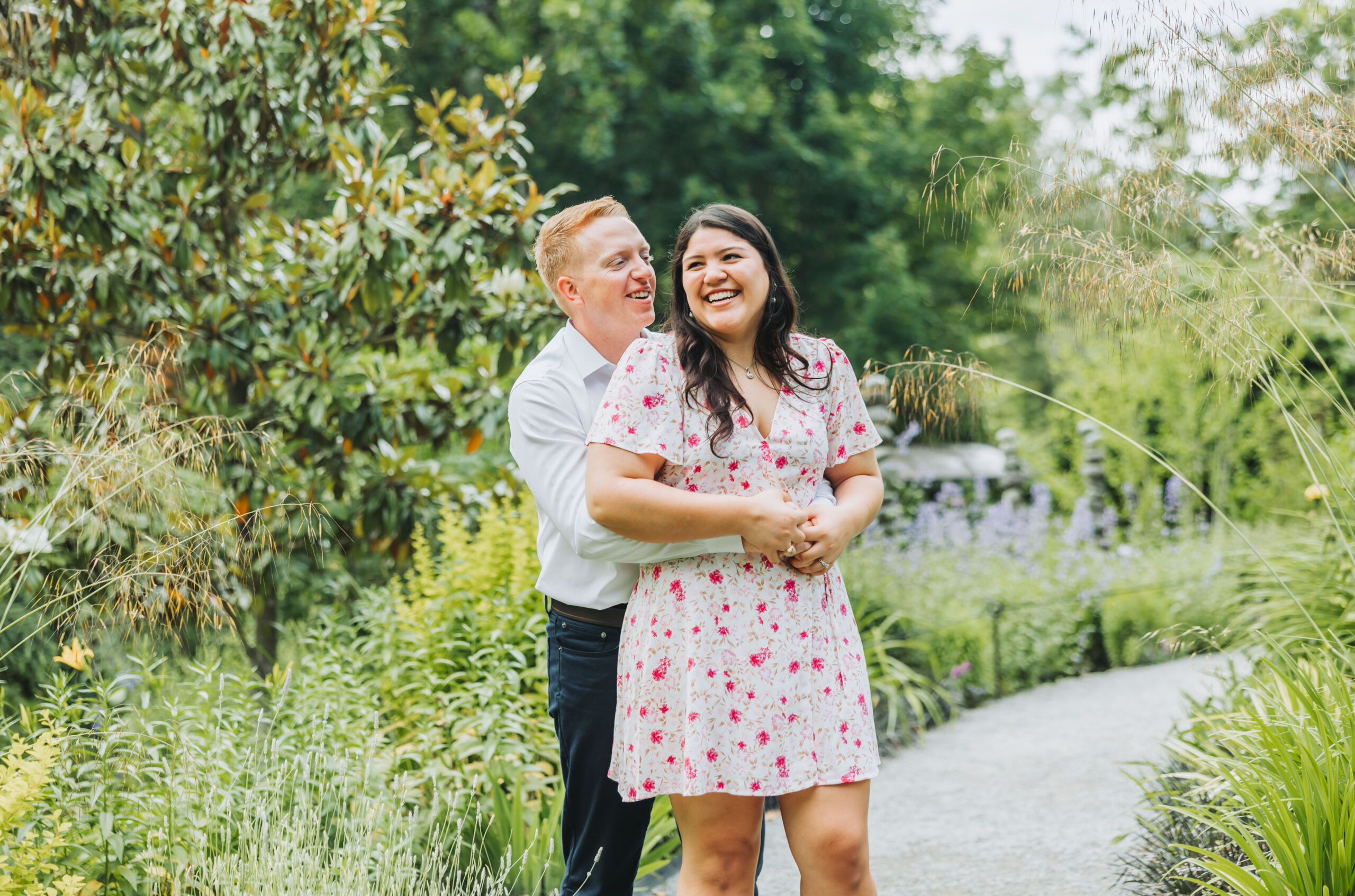 An engaged couple celebrating together at Bellevue Botanical Garden in Bellevue, WA