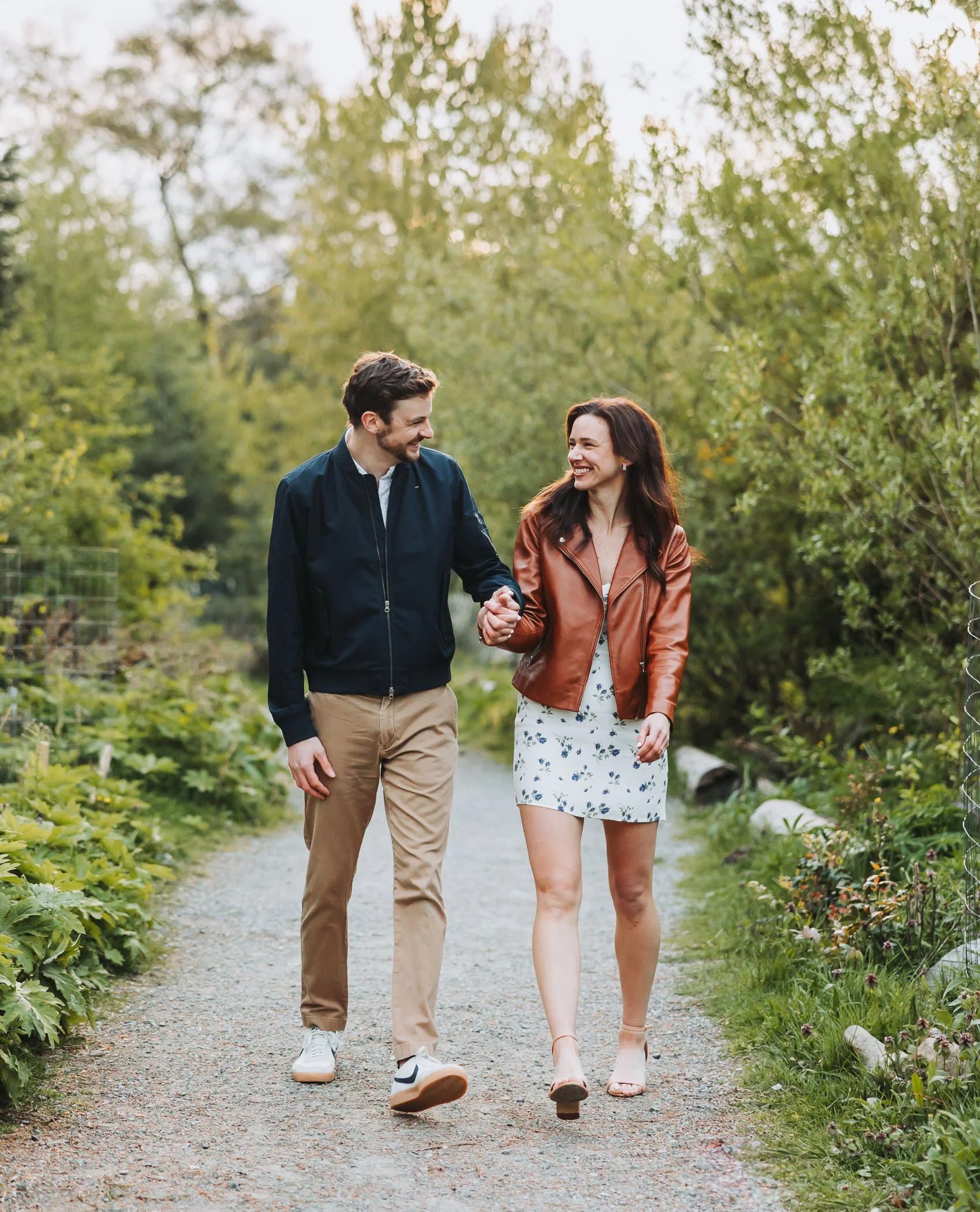 Couple walking down a pathway at Discovery Park in Seattle, WA
