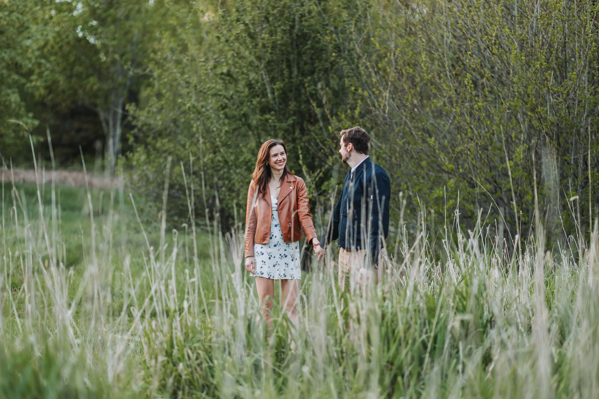 Couple enjoy each other behind high grass at Discovery Park in Seattle, WA