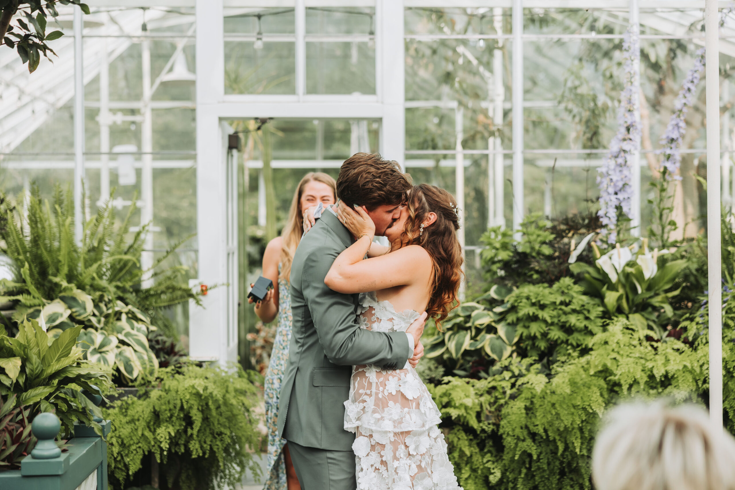 Bride and Groom having their first kiss and the Volunteer Park Conservatory in Seattle, WA