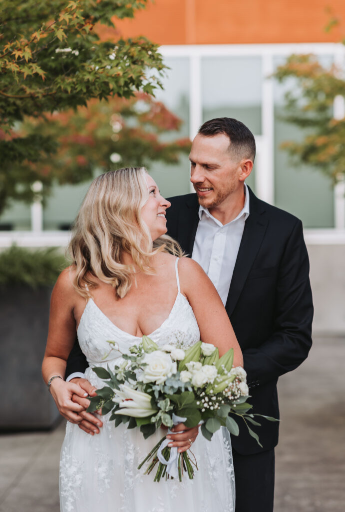 Bride and Groom Enjoying a Moment together at Bothell Courthouse in Bothell, Washington after their Courthouse Elopement Ceremony