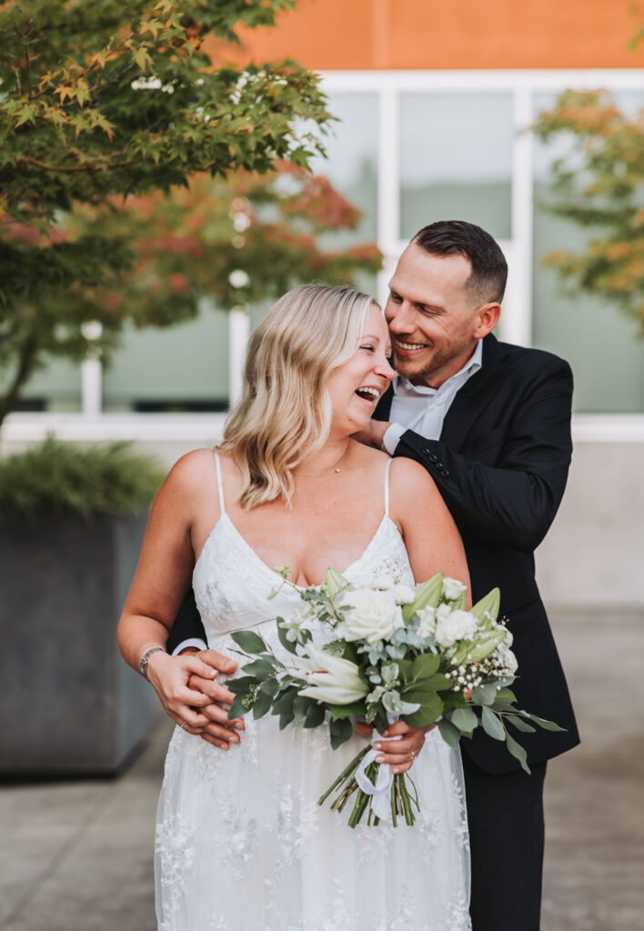 Bride and Groom Enjoying a Moment together at Bothell Courthouse in Bothell, Washington after their Courthouse Elopement Ceremony