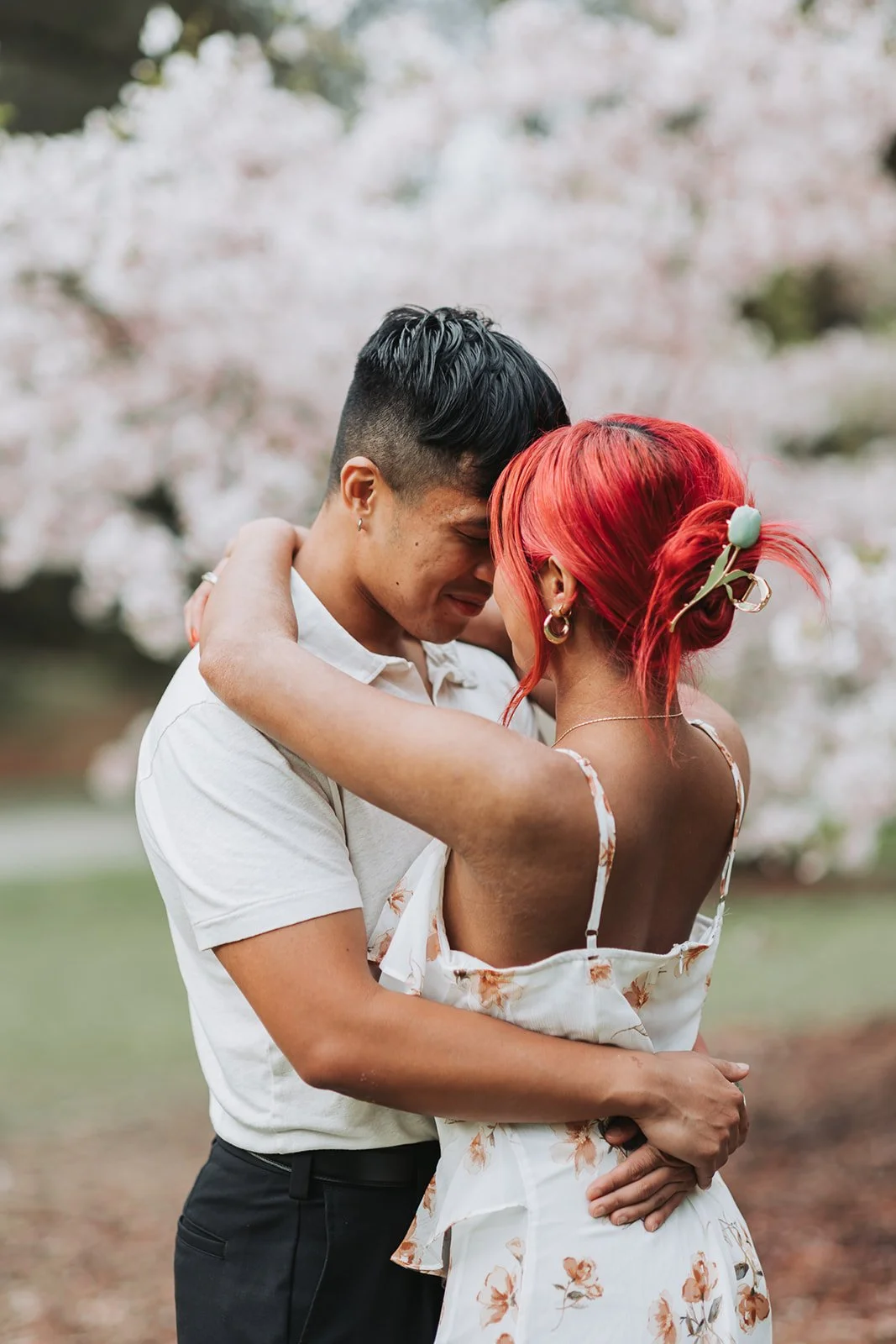 Couple enjoy their engagement session at Washington Park Arboretum in Seattle, WA during Cherry Blossom Seasons