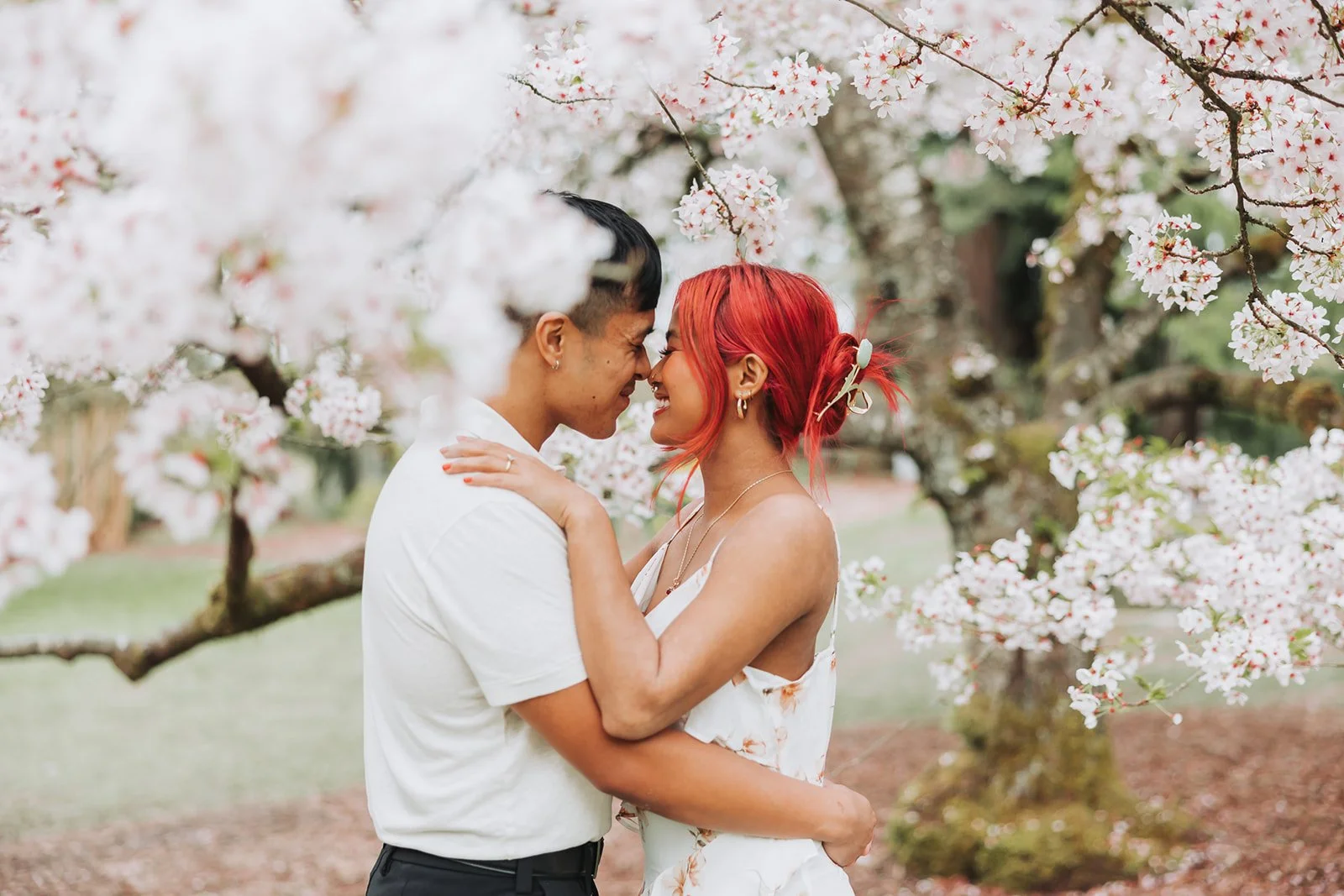 Couple enjoy their engagement session at Washington Park Arboretum in Seattle, WA during Cherry Blossom Seasons