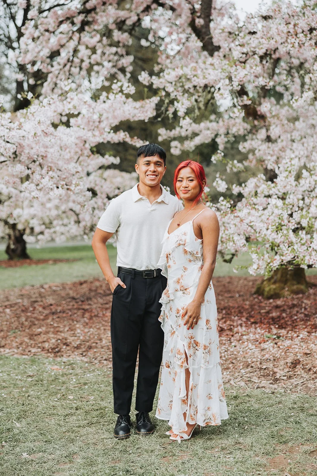Couple enjoy their engagement session at Washington Park Arboretum in Seattle, WA during Cherry Blossom Seasons