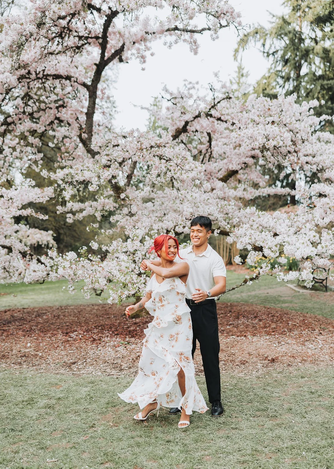 Couple enjoy their engagement session at Washington Park Arboretum in Seattle, WA during Cherry Blossom Seasons