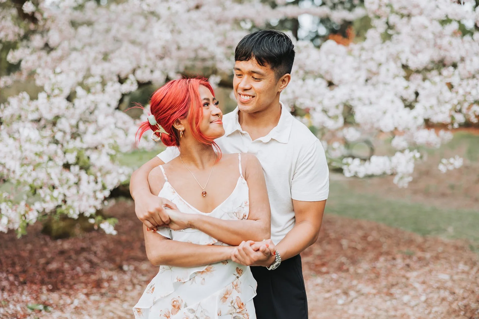 Couple enjoy their engagement session at Washington Park Arboretum in Seattle, WA during Cherry Blossom Seasons