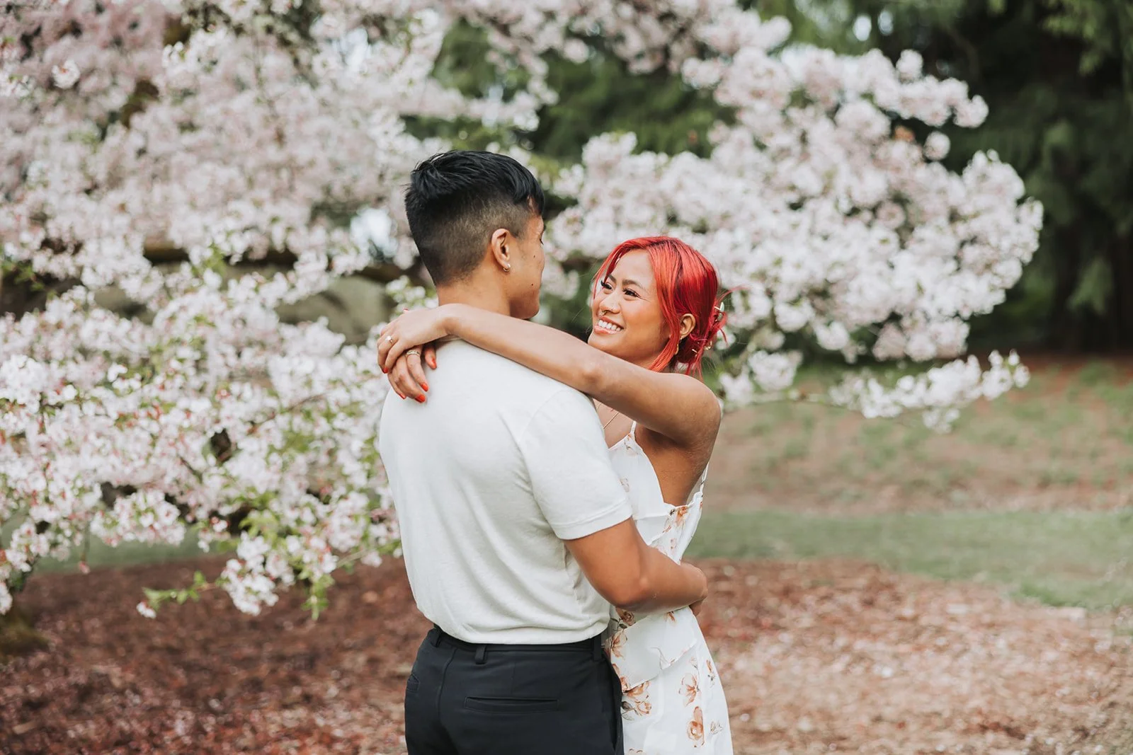Couple enjoy their engagement session at Washington Park Arboretum in Seattle, WA during Cherry Blossom Seasons