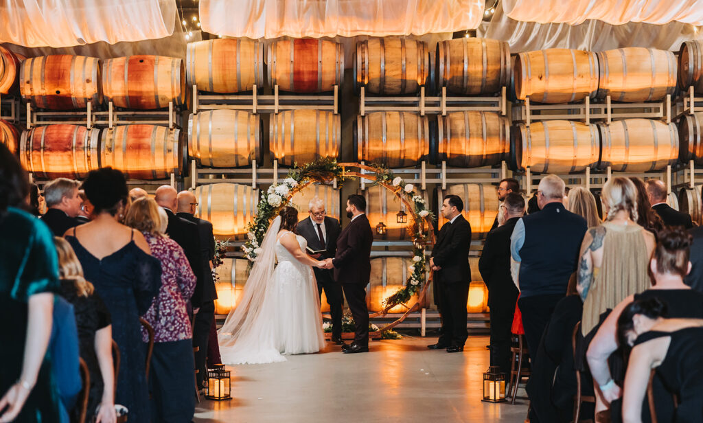 Bride and Groom at their Ceremony in the Barrell Room at Columbia Collective in Woodinville, WA